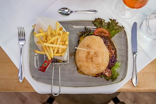 Großer Burger mit Speck, Tomaten, Salat und Pommes Frites